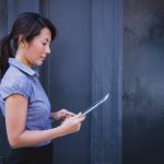 lady walking with ipad