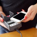 woman using apple pay at POS system