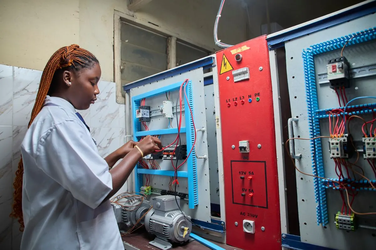 Electrician working on an electrical control panel