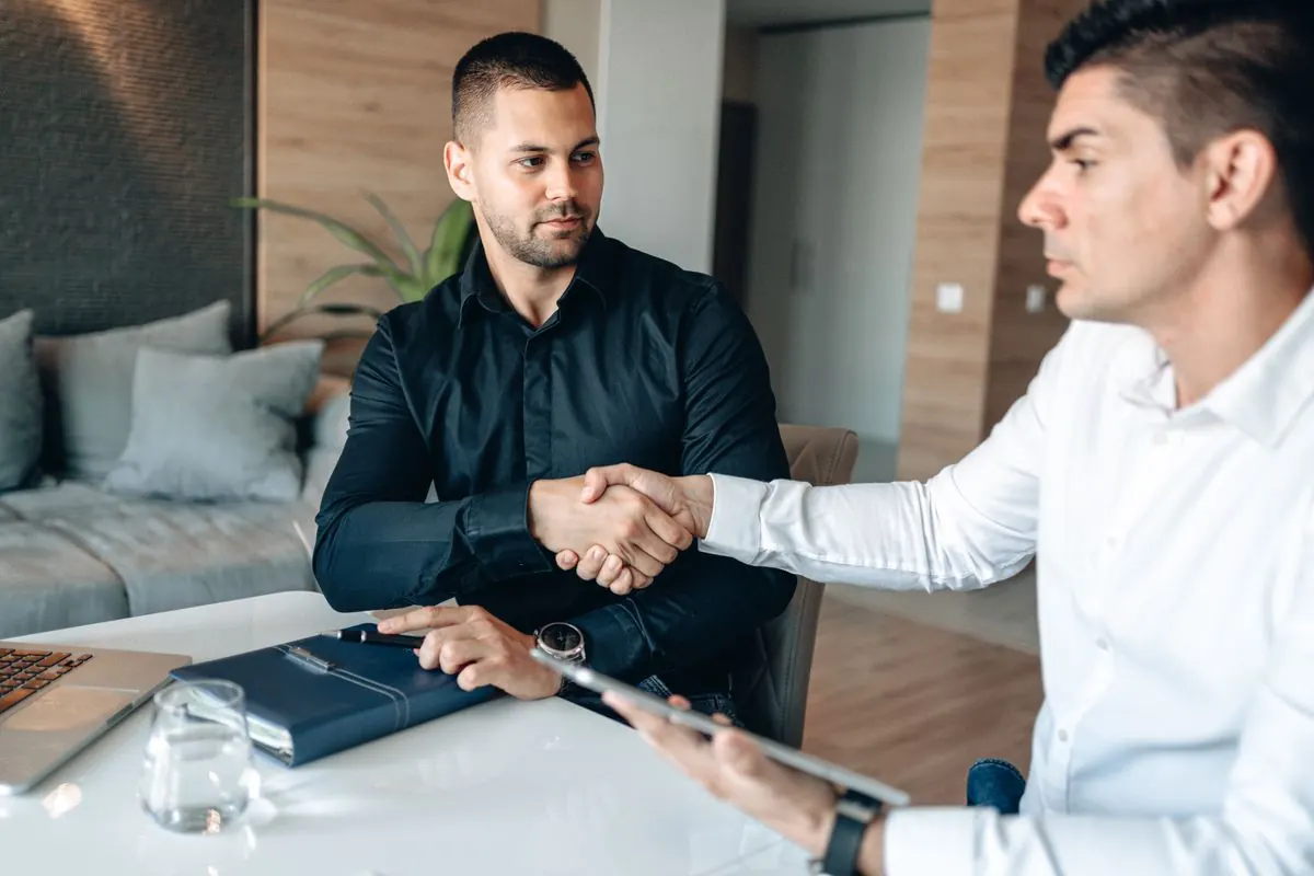 Business partners shaking hands on a Square and KORONA POS partnership