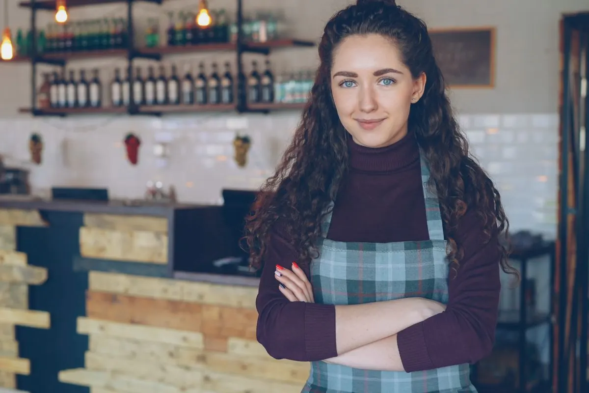 Restaurant owner standing at her counter, a typical Square POS business