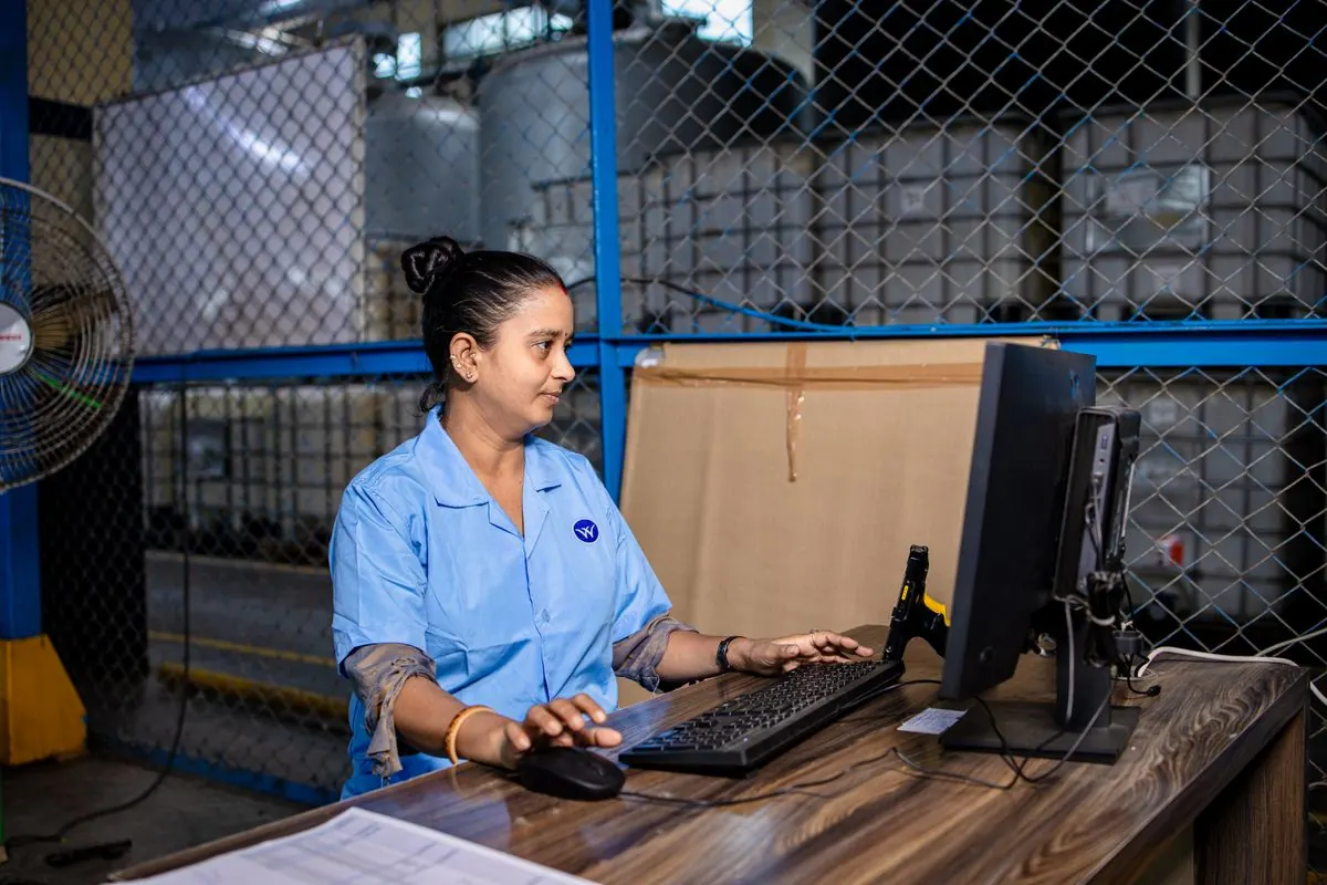 Worker exporting inventory data at a computer before a POS migration