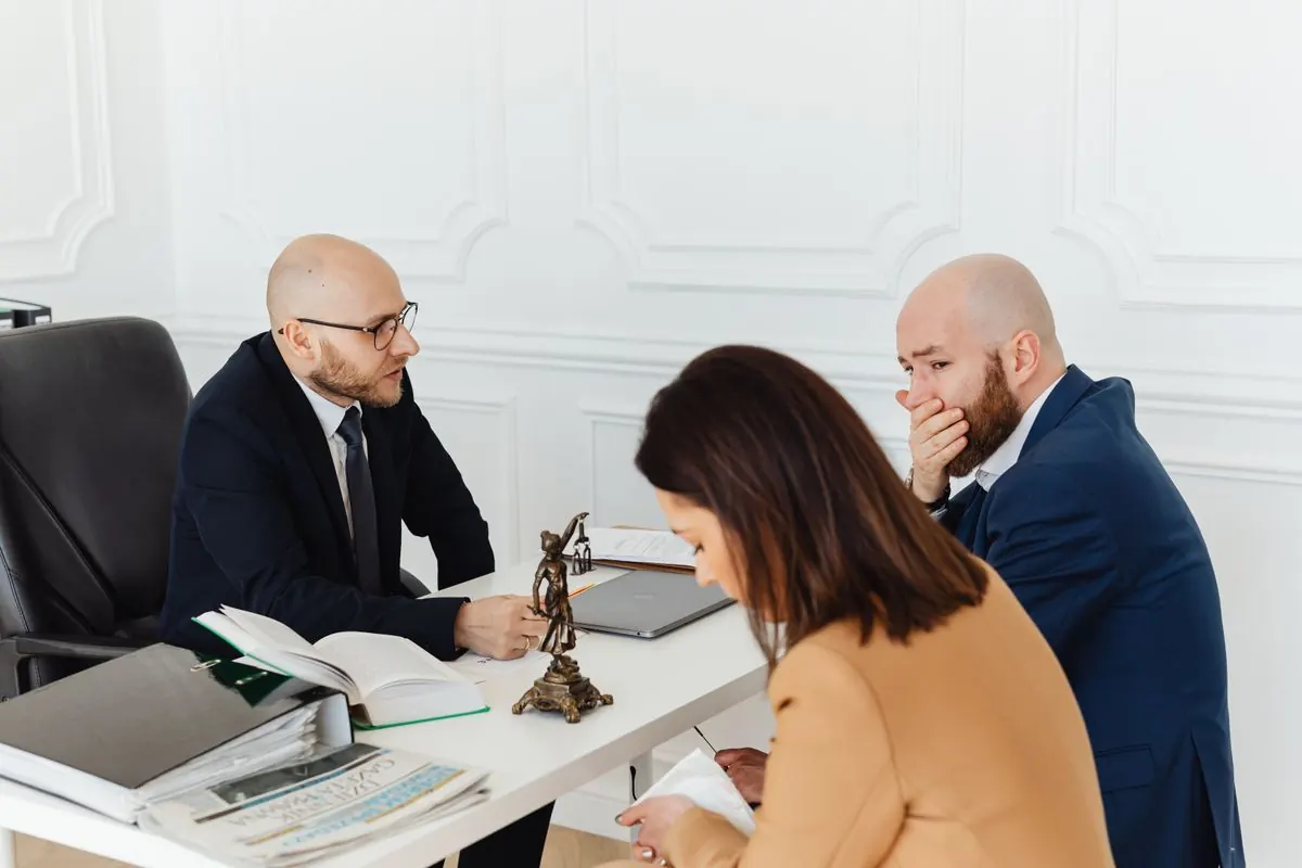 Lawyers meeting a client in a law firm office, where trust account credit card processing matters
